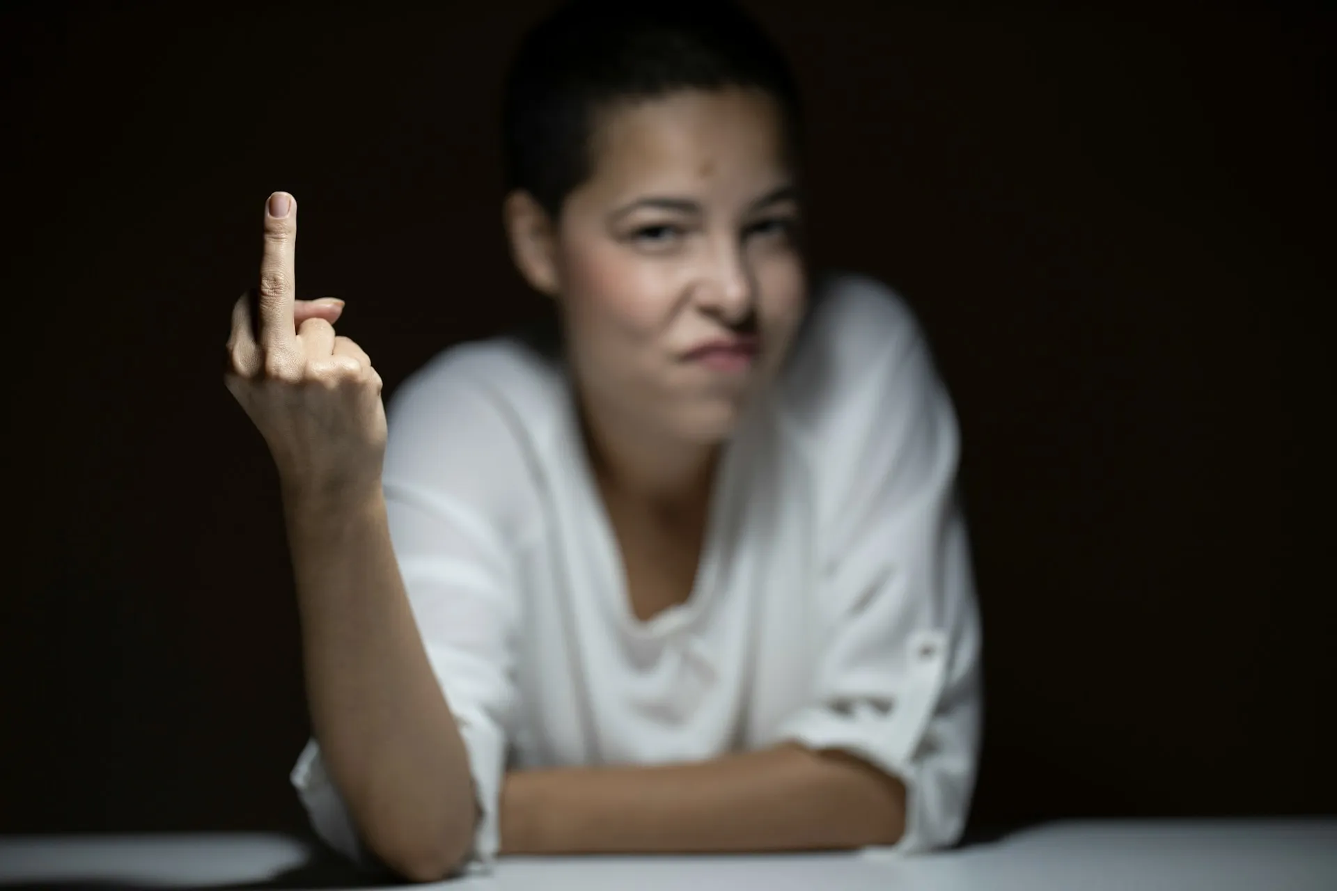 Photo of a person sticking a middle finger up at the camera