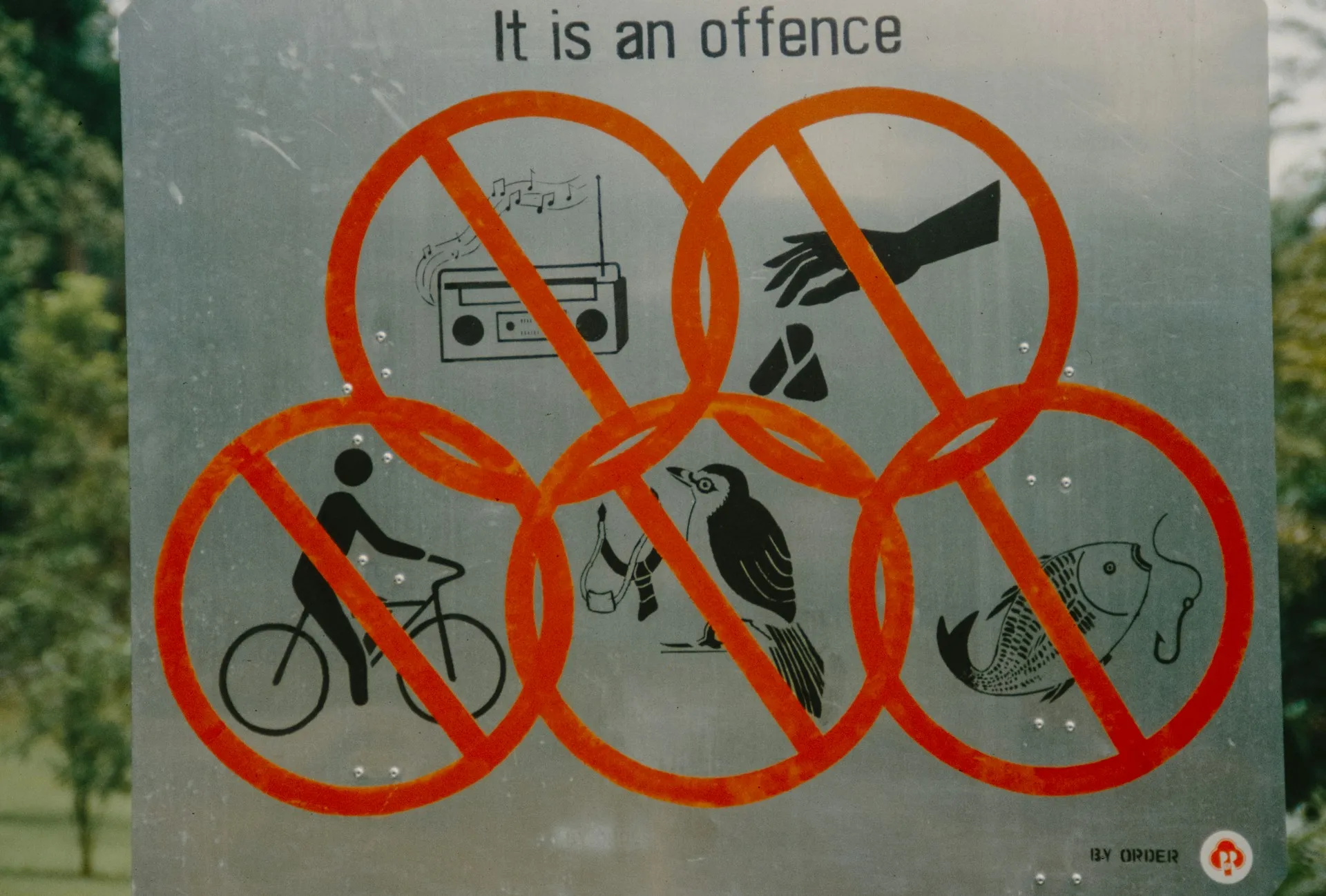 A rules sign prohibiting many fun things including music and cycling